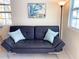 Cozy living room with a black leather pull-out sofa and accent pillows at 5407 29Th S Ave, Gulfport, FL 33707