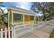 Charming light green cottage with white picket fence and porch at 5407 29Th S Ave, Gulfport, FL 33707