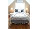 Upstairs bedroom with white iron bed and gray bedding at 5407 29Th S Ave, Gulfport, FL 33707