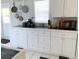 Well-equipped kitchen with white cabinets and tile countertops at 5407 29Th S Ave, Gulfport, FL 33707