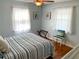 Bright bedroom with a striped bedspread and wood floors at 5407 29Th S Ave, Gulfport, FL 33707