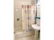 Bright bathroom with tub and coastal-themed shower curtain at 5407 29Th S Ave, Gulfport, FL 33707