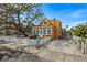 Charming yellow house with white picket fence and mature oak tree at 5407 29Th S Ave, Gulfport, FL 33707