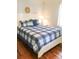 Cozy bedroom featuring a white bed frame and blue plaid bedding at 5407 29Th S Ave, Gulfport, FL 33707