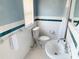 Clean bathroom with white tile and teal accents at 5407 29Th S Ave, Gulfport, FL 33707