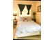 Bedroom with striped bedspread and coastal decor at 5407 29Th S Ave, Gulfport, FL 33707