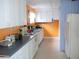 Orange-walled kitchen with white cabinets at 5407 29Th S Ave, Gulfport, FL 33707