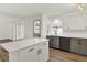 Modern kitchen with white cabinets, quartz countertops, and island at 1934 Par Pl, Sarasota, FL 34240