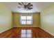 Spacious bedroom featuring wood flooring and a ceiling fan at 2331 W Del Webb Blvd, Sun City Center, FL 33573