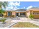 House exterior with walkway, landscaping, and two-car garage at 2331 W Del Webb Blvd, Sun City Center, FL 33573