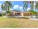 Single story house with palm trees, well maintained lawn, and a two car garage at 2331 W Del Webb Blvd, Sun City Center, FL 33573