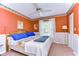 Bedroom with a king-size bed and rich orange walls at 3042 Lake Saxon Dr, Land O Lakes, FL 34639