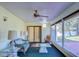 Relaxing sunroom with wicker furniture, ceiling fan, and view of the backyard at 3042 Lake Saxon Dr, Land O Lakes, FL 34639