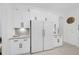 Kitchen featuring white cabinets and a large stainless steel refrigerator at 3073 Woodsong Ln, Clearwater, FL 33761