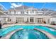 Large pool and spa with covered patio and outdoor seating at 3073 Woodsong Ln, Clearwater, FL 33761