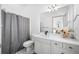 Modern bathroom with quartz countertop and gray shower curtain at 3073 Woodsong Ln, Clearwater, FL 33761