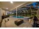 Relaxing screened-in pool area with fire pit and comfortable seating at 3073 Woodsong Ln, Clearwater, FL 33761