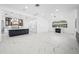 Open living room and kitchen with marble floors and fireplace at 3073 Woodsong Ln, Clearwater, FL 33761