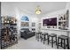 Wet bar with wine storage, TV, and comfortable seating at 3073 Woodsong Ln, Clearwater, FL 33761