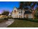 Stunning home exterior view at dusk with walkway and landscaping at 3073 Woodsong Ln, Clearwater, FL 33761