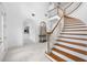 Bright and spacious entryway with a grand staircase and marble floors at 3073 Woodsong Ln, Clearwater, FL 33761
