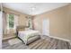 Serene bedroom featuring wood-look flooring and ample natural light at 3073 Woodsong Ln, Clearwater, FL 33761