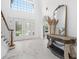 Elegant entryway with double doors, marble floors, and statement light fixture at 3073 Woodsong Ln, Clearwater, FL 33761