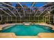 Screened pool and spa at dusk at 3073 Woodsong Ln, Clearwater, FL 33761