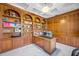 Home office with built-in wooden shelves and large desk at 3073 Woodsong Ln, Clearwater, FL 33761