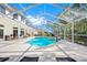 Enclosed pool and patio area with lounge chairs at 3073 Woodsong Ln, Clearwater, FL 33761