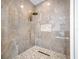 Large walk-in shower with marble tile and gold fixtures at 3073 Woodsong Ln, Clearwater, FL 33761