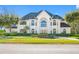 Impressive two-story house with a grand entrance and manicured lawn at 3073 Woodsong Ln, Clearwater, FL 33761