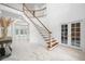 Elegant entryway with marble floors, curved staircase, and double doors at 3073 Woodsong Ln, Clearwater, FL 33761