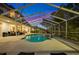 Enclosed pool and spa area with a beautiful sunset view at 3073 Woodsong Ln, Clearwater, FL 33761