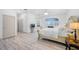 Main bedroom with hardwood floors and an ensuite bathroom at 3073 Woodsong Ln, Clearwater, FL 33761