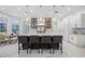 Modern kitchen with large island, white cabinetry, and marble flooring at 3073 Woodsong Ln, Clearwater, FL 33761