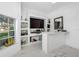 Modern home bar with ample storage and a large TV at 3073 Woodsong Ln, Clearwater, FL 33761