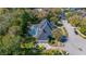 Aerial view of house, pool, and surrounding landscape at 3073 Woodsong Ln, Clearwater, FL 33761