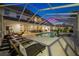 Evening view of a large pool and patio area at 3073 Woodsong Ln, Clearwater, FL 33761