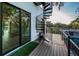 Modern deck featuring spiral stairs and access to pool area at 3165 Renatta Dr, Belleair Bluffs, FL 33770