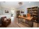 Home office with built-in shelving and a large wooden desk at 3165 Renatta Dr, Belleair Bluffs, FL 33770