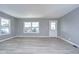 Bright living room with gray walls and wood-look flooring at 39053 Flora Ave, Zephyrhills, FL 33542