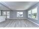 Bright living room featuring grey walls and vinyl plank flooring at 39053 Flora Ave, Zephyrhills, FL 33542