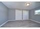 Spacious bedroom with gray walls, wood-look floors, and double closets at 39053 Flora Ave, Zephyrhills, FL 33542