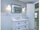 Clean bathroom with white vanity, quartz countertop, and a large mirror at 39053 Flora Ave, Zephyrhills, FL 33542