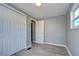 Bedroom with gray walls, wood-look floors, and white closets at 39053 Flora Ave, Zephyrhills, FL 33542