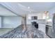Modern kitchen with white shaker cabinets, stainless steel appliances, and a large island at 39053 Flora Ave, Zephyrhills, FL 33542