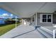 Mobile home exterior with covered patio and gray siding at 39053 Flora Ave, Zephyrhills, FL 33542