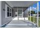 Spacious screened porch with steps and railing at 39053 Flora Ave, Zephyrhills, FL 33542