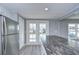 Modern kitchen with white shaker cabinets, stainless steel appliances and a large island at 39053 Flora Ave, Zephyrhills, FL 33542